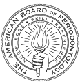The image shows a circular seal with intricate patterns and text around the edge, featuring a central emblem that appears to be a stylized letter  A  with a wreath of laurel leaves encircling it.