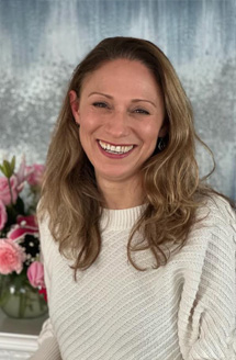 Woman with a smile, posing for a portrait.